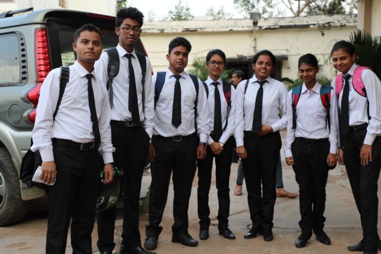 Students in formal uniforms posing together outdoors on the ISM Ranchi campus