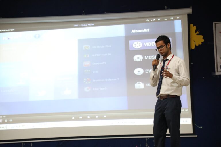 A student presenting beside a projected slide during an ISM Ranchi learning session