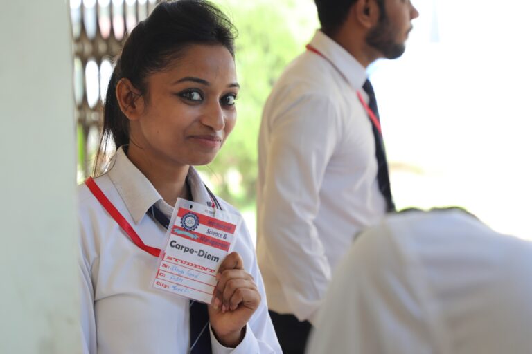 A hospitality student in a white uniform during an ISM Ranchi campus activity