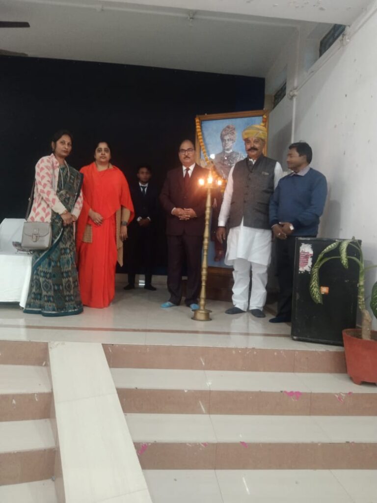 Guests gathered beside a ceremonial lamp at an ISM Ranchi event