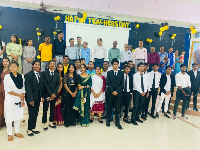 Students and faculty posing in front of a Happy Teachers Day backdrop at ISM Ranchi