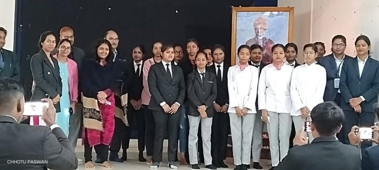 Students in formal attire posing together at an ISM Ranchi indoor event