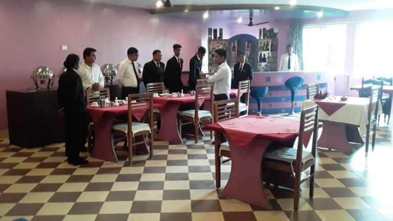 Students practising table service in an ISM Ranchi hospitality training room