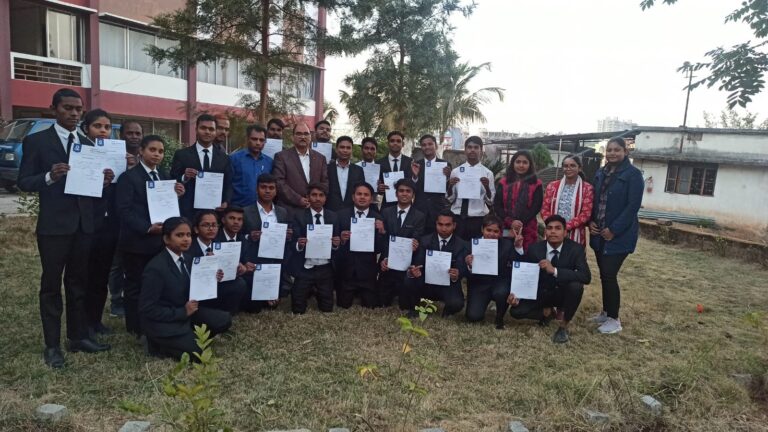 Students displaying certificates during an outdoor ISM Ranchi gathering