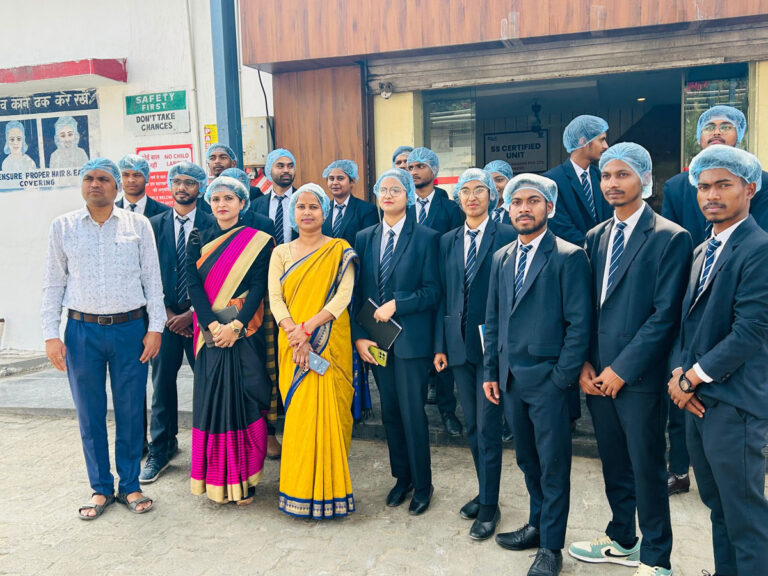 Students in formal uniforms and faculty posing outside an ISM Ranchi academic building